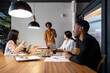 © Bisual Studio/Stocksy - Diverse businesspeople listening to black colleague