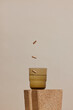 © Nicole Mason/Stocksy - beauty product still life of supplement pills and glass of water