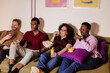© Boris Jovanovic/Stocksy - Friends watching tv at home