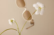 © Nicole Mason/Stocksy - pair of sunglasses floating in scene with white flower