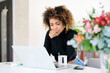 © Guille Faingold/Stocksy - Businesswoman working on her laptop at home.