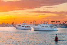 Yachts On The Dock In The Port Against The Backdrop Of Sunset On The Ocean. California. Newport Beach
