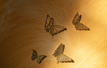 Four Golden Butterflies On The Wall