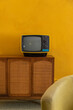 © Raymond Forbes LLC/Stocksy - Vintage Seventies Analog Television on sideboard cabinet