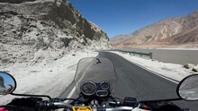 POV Motorcyclist Riding Motorbike By Scenic Mountain Road In Himalayas. Biker On Motorcycle Going Between Mountain Valley By Landscape Path. Steering Wheel View. Moto Trip