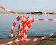 © Duet Postscriptum/Stocksy - Plastic fencing and warning tape in the port