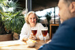 © Pedro Merino/Stocksy - Couple having a beer in an outdoor restaurant