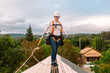 © ByLorena/Stocksy - Female roofer working on top roof