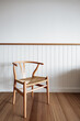 © Jodie Johnson Photography/Stocksy - Minimalist wooden chair against blank wall