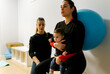 © Marco Govel/Stocksy - Mother and baby attending a postpartum recovery class