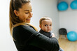 © Marco Govel/Stocksy - Mother and baby attending a postpartum recovery class