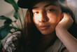 © BONNINSTUDIO/Stocksy - User-generated content freckled teen girl resting on living room