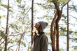 © Sophia Hsin/Stocksy - Young woman forest bathing/relaxing in forest