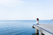 © Vero./Stocksy - Cool woman relaxing on a pier