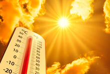 Hot Temperature,Thermometer On Yellow Sky With Sun Shining In Summer Show Higher Weather, Concept Global Warming