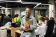 © STUDIO TAURUS/Stocksy - Young Businessman Holding A Laptop