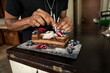 © Sean Locke/Stocksy - Loft: Man Puts Birthday Candle In Fancy Cake