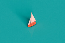 A Pink Sail Boat On A Blue Background