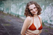 © Luciano Spinelli/Stocksy - Candid portrait of a curly hair woman in a old urban area