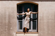 © Tania Cervian/Stocksy - Woman near window of old building
