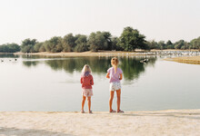 Two Girls On The Lake With Flamingoes