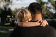 © Samantha Gehrmann/Stocksy - a daughter hugs her father at sunrise