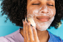 Hispanic Woman Cleansing Face With Handmade Soap