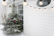 © Léa Jones/Stocksy - snowy Christmas tree on patio