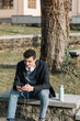 © Alberto Bogo/Stocksy - Boy Looking At Phone In A Park