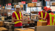 © Me studio - Male and female warehouse workers work at a distribution center. Closing the product use a scanner Analyze new arrivals of additional items in the warehouse department. Employees who organize the