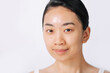 © Marc Tran/Stocksy - Unmakeup smiling young asian female with fresh facial skin
