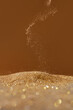 © Yaroslav Danylchenko/Stocksy - Close up of falling golden sand