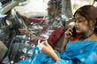 © Dream Lover/Stocksy - Indian young couple sitting inside a car and browsing smartphone
