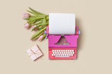Tulips And Gift Box Lying Near Retro Typewriter