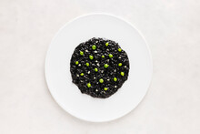 Delicious Black Risotto Rice With Green Beans On White Plate