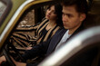 © Alexander Gospodinov/Stocksy - A stylish couple inside a car