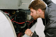 Pilot Checking The Engine Of The Plane
