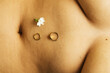 © Sophia Hsin/Stocksy - Jewelry and jasmine flower on belly button