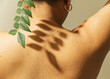 © Sophia Hsin/Stocksy - Leafy shadow on a young womans' bare back
