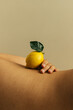 © Sophia Hsin/Stocksy - Curve of woman's waist with lemon balanced on top