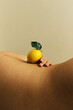 © Sophia Hsin/Stocksy - Curve of woman's waist with lemon balanced on top