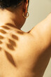 © Sophia Hsin/Stocksy - Leafy shadow on a young womans' bare back