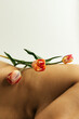 © Sophia Hsin/Stocksy - Tulip balanced on bare skin and curves