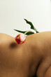 © Sophia Hsin/Stocksy - Tulip balanced on bare skin and curves