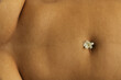 © Sophia Hsin/Stocksy - Single jasmine flower on belly button