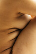 © Sophia Hsin/Stocksy - Curvy bare side profile of young woman
