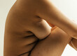 © Sophia Hsin/Stocksy - Curvy bare side profile of young woman