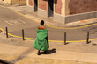 © Alba Vitta/Stocksy - Black man walking through the town with overcoat