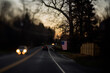 © Deirdre Malfatto/Stocksy - driving past an American flag on a country road