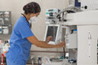© Javier Pardina/Stocksy - Nurse preparing settings of a mechanical ventilation machine